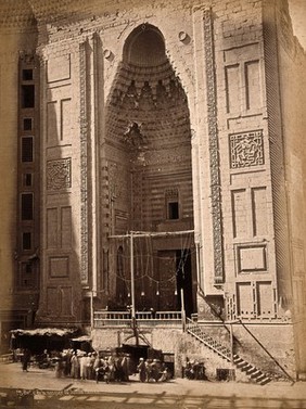 The Sultan Hassan mosque, Cairo, Egypt: the doorway with a crowd gathered outside. Photograph by Pascal Sébah (?), ca. 1870.
