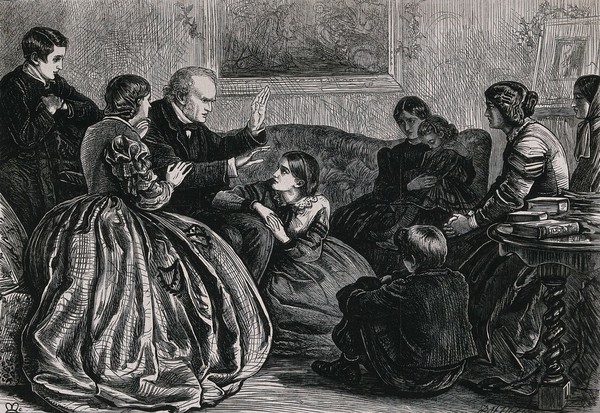 A family group of women and children sitting listening to a man telling a story at Christmas. Wood engraving by Dalziel after J.E. Millais.