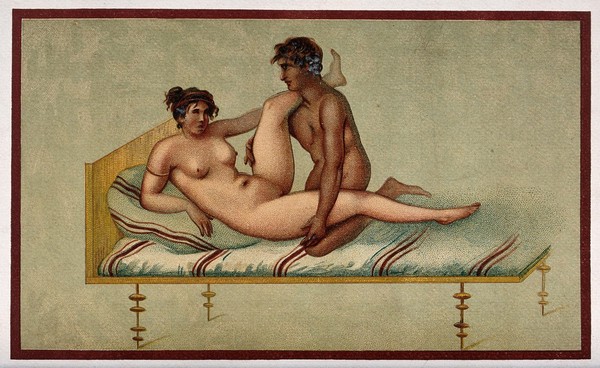 A naked man and woman in sexual congress on a bed. Coloured process print.