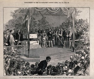 view A couple stand on a platform where a large stone is suspended on a chain and a great crowd of people are watching the event. Wood engraving.