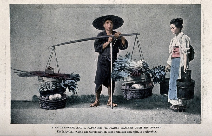 A man in Japan with two panniers filled with vegetables suspended from a yoke is accompanied by a woman carrying buckets. Colour process print.