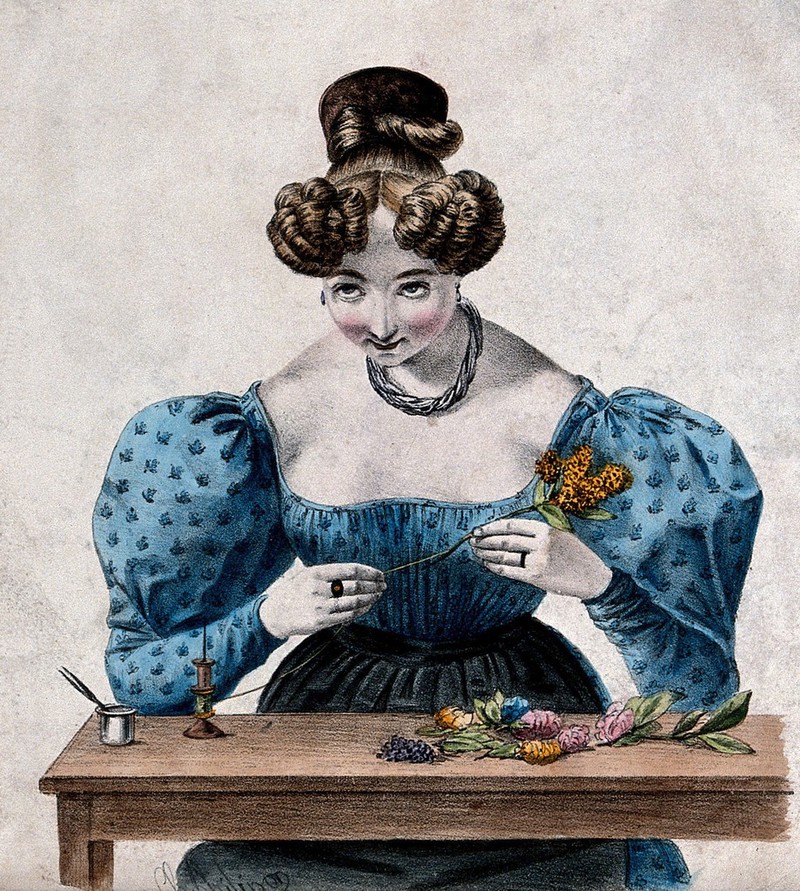 A woman is winding cotton around the stems of flowers. Coloured lithograph by Charles Philipon., by Charles Philipon