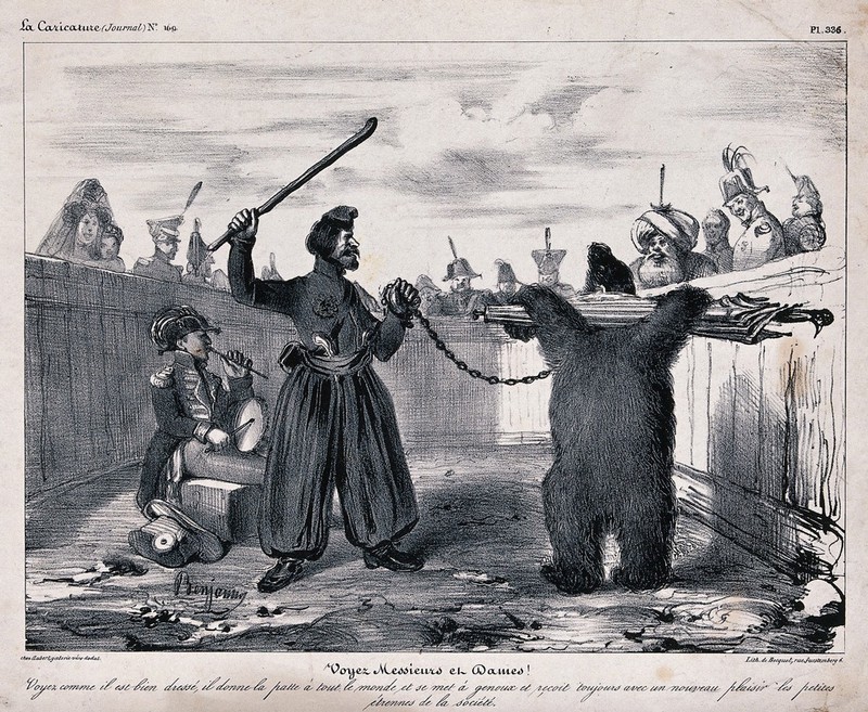 A soldier plays a drum as a man with a chained bear with its arms held back by an umbrella is making it dance to entertain the crowd. Lithograph by Benjamin Roubaud, 1833., [1833], by Benjamin Roubaud