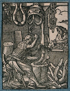 A saddler making saddles and girths for horses; saddles and bridles are displayed in the workshop. Woodcut by J. Amman.