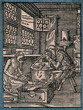 A man and a woman making pins and needles. Woodcut by J. Amman.