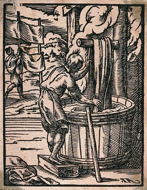 view A dyer of cloth is dipping fabric into a large barrel as other sheets are hung up to dry. Woodcut by J. Amman..