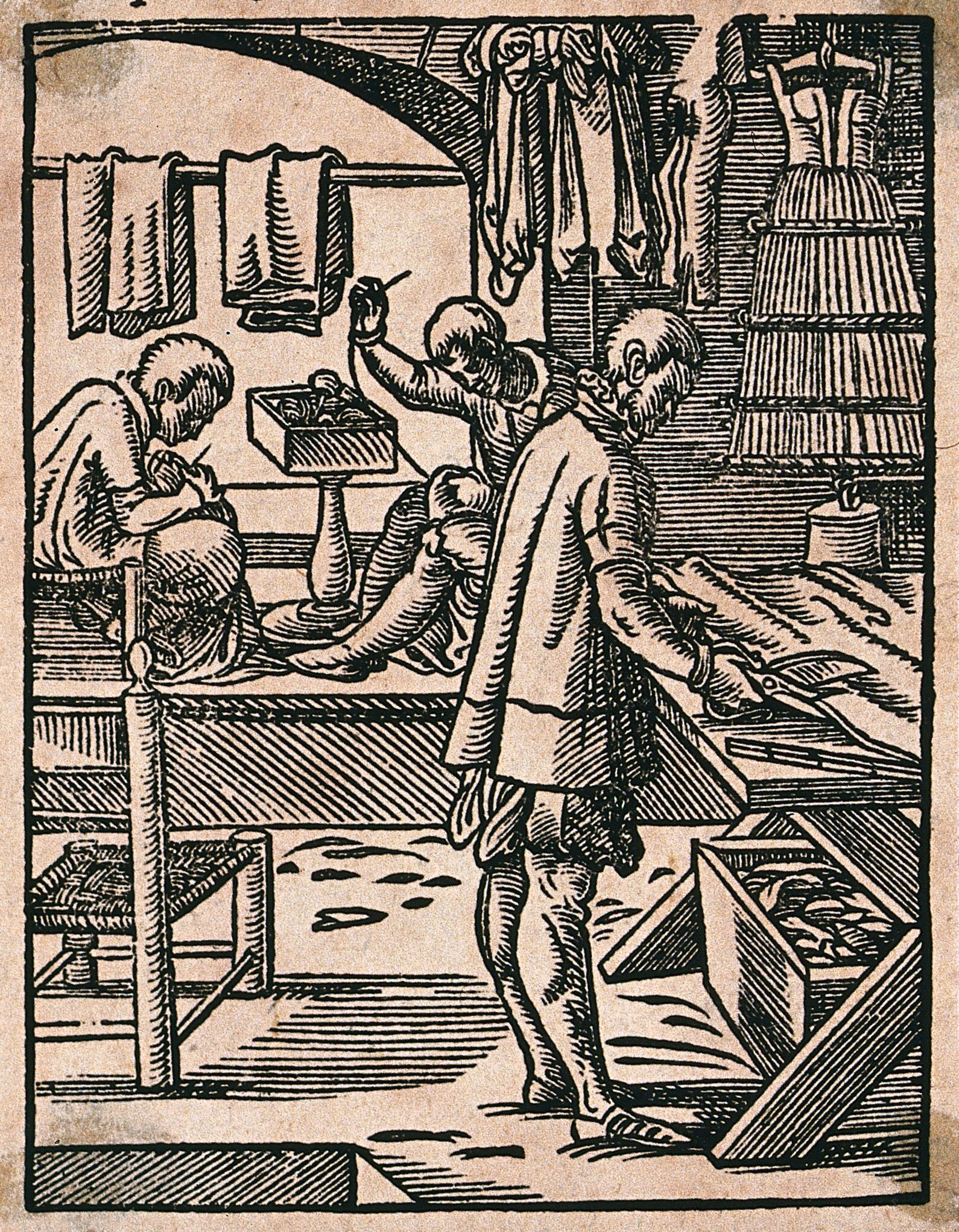 One Man Is Cutting Cloth With A Large Pair Of Scissors As Other