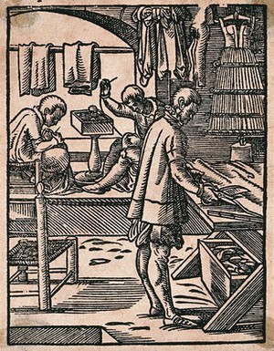 view A tailor cutting cloth with scissors while his colleagues sew at a bench. Woodcut by J. Amman.