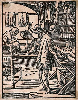 A tailor cutting cloth with scissors while his colleagues sew at a bench. Woodcut by J. Amman.