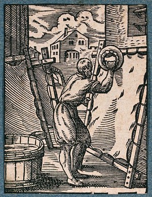 view A parchment-maker smoothing an animal hide on a stretcher. Woodcut by J. Amman..