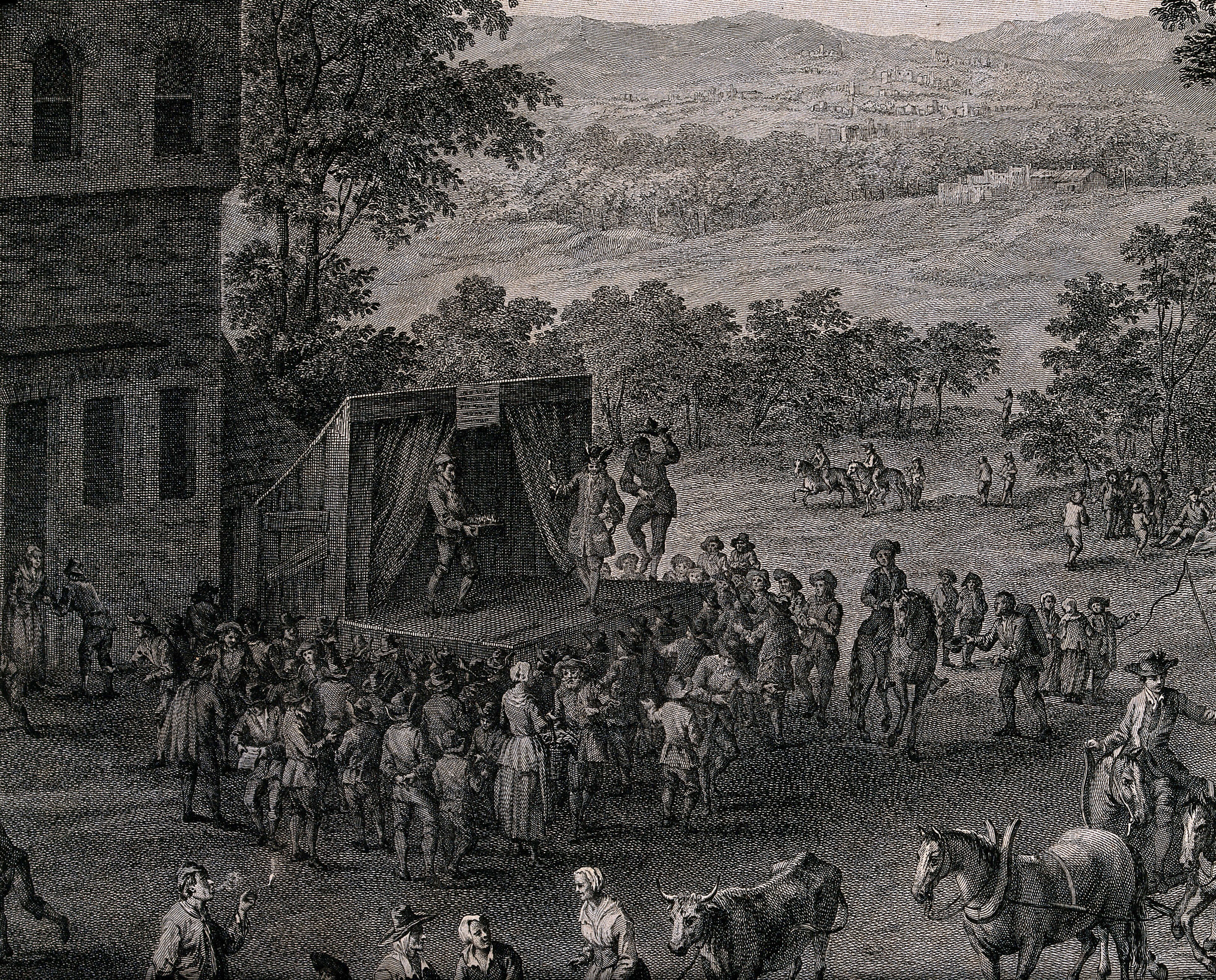 Crowds of people are gathered for a fete, a stage has been set up and actors are performing a play. Engraving by F. Dequevauviller, 1777, after M. Schoevaerdts.