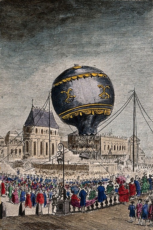 Crowds of people are watching in the streets as a hot-air balloon leaves the ground. Coloured etching after Char. de Lovinier.