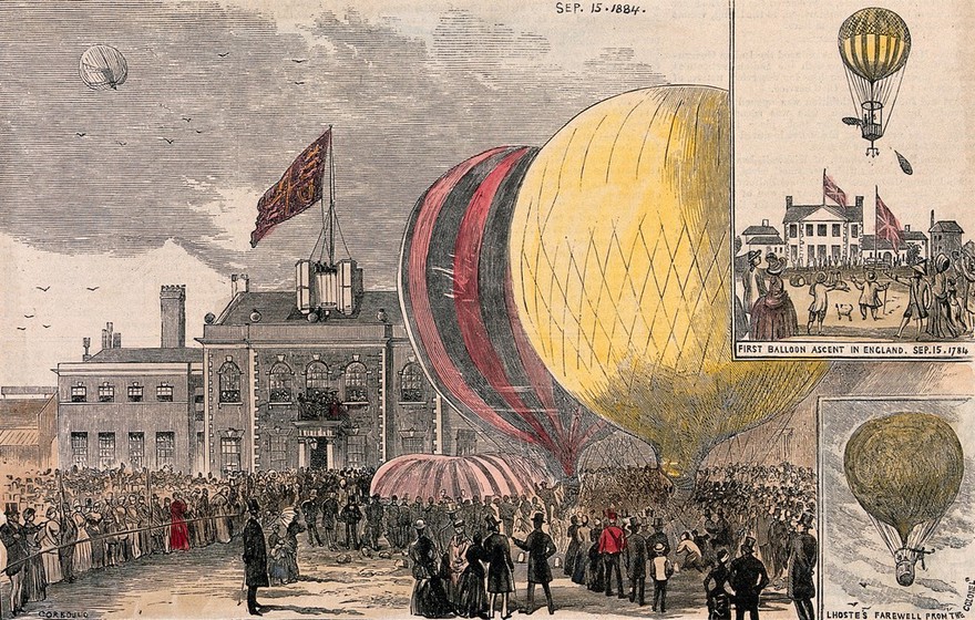 Crowds of people gathered in a square, with hot-air balloons on the ground. Coloured wood engraving after Corbould, 1884.