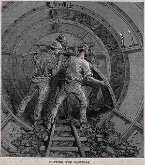 view Workmen fitting metal casings to form an underground tunnel. Wood engraving, 1868.