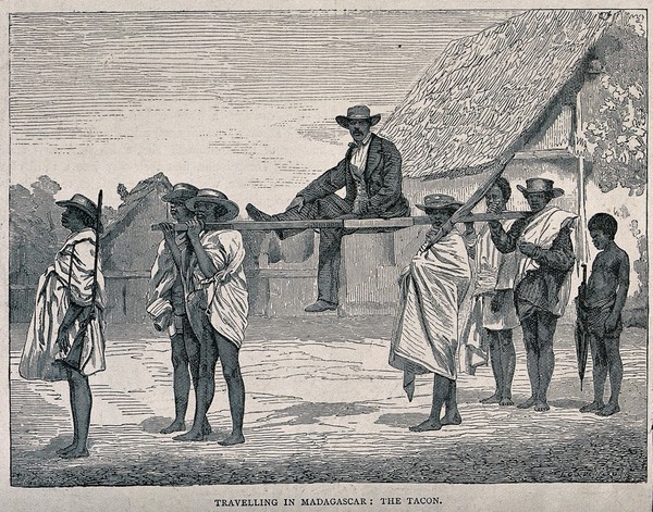 A man in Madagascar being carried on a litter on the shoulders of four men. Wood engraving by F.-J. Gauchard.