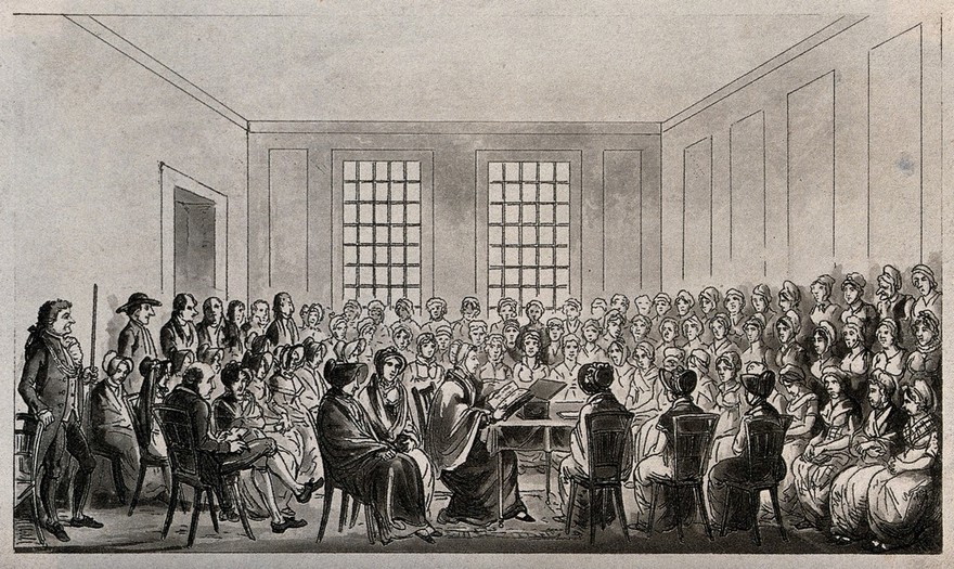 Elizabeth Fry is seated at a table in Newgate Prison, London, surrounded by women prisoners listening to her. Etching and aquatint.