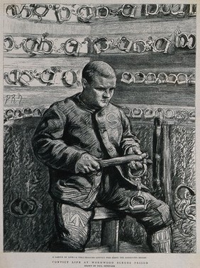 Wormwood Scrubs Prison, London: a prisoner in the chain-room where manacles are stored: he is cleaning them. Process print after Paul Renouard.