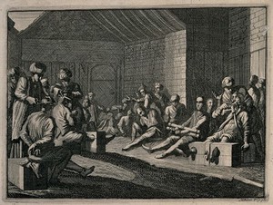 view Male prisoners are sitting with their legs in stocks and their hands tied as men in turbans cut off their hair and moustaches. Etching.