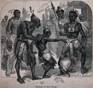 view Methods of torture in Africa: a man is forced to catch a very hot iron ring with his bare hands above a cauldron over a fire. Wood engraving by H.S. Melville.