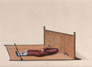 view A Chinese man confined to a contraption similar to stocks which constrains the movement of his head and pins his legs down on the wooden planks. Watercolour drawing.