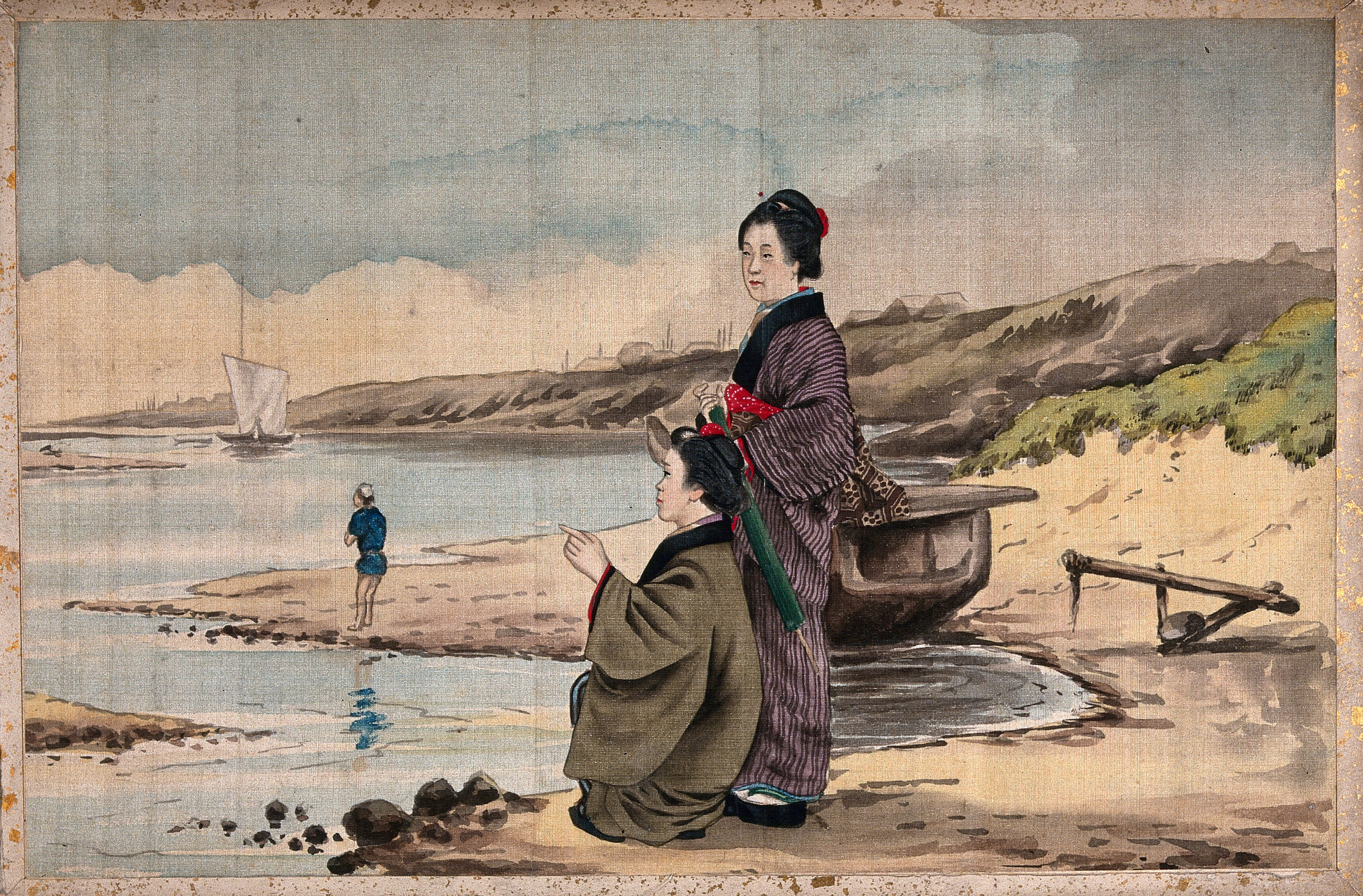 Two Japanese Women On A Sandy Shore One Crouches Down And Points