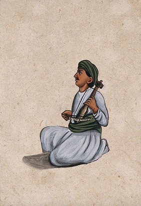 An Indian musician playing a violin. Gouache painting by an Indian artist.