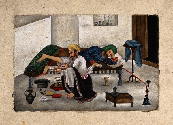 A surgeon, sitting on the floor, attends to a patient's leg, as he lies on a bed. Gouache painting by an Indian artist, ca. 1825.