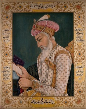 A Mughal emperor or member of a royal family reading a book. Gouache painting by an Indian painter.