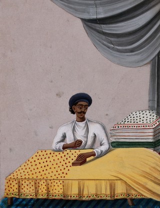 A man block printing on textiles. Gouache painting on mica by an Indian artist.