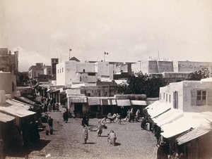 view Algeria (?): view of the buildings, street and shops. Photograph.