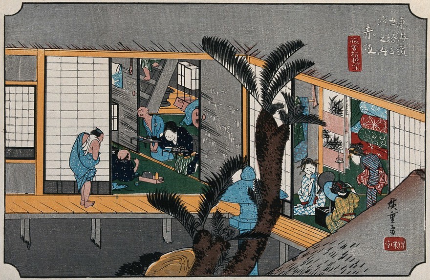 A scene inside an inn: left, a guest is waited on by a servant girl bringing food, and by a blind masseur; right, in another room, geishas apply cosmetics to their faces. Reprint (ca. 1900) of coloured woodcut by Hiroshige, 1834.