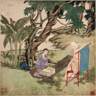 A Buddhist master (?) sitting on a chair under a tree, with books laid out on a table, while a young pupil kneels before him. Watercolour with gouache, China (?), 1750/1850?.