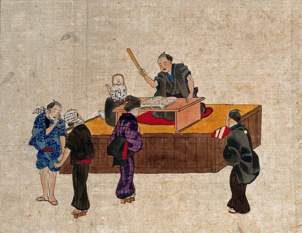 A man sits at a table on a platform reciting from a book, while three women and a man stand nearby. Coloured drawing (?).