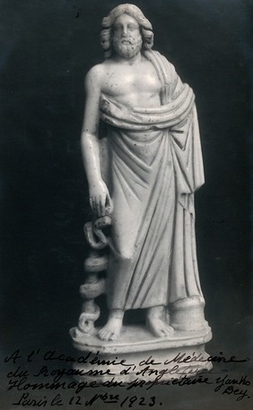 Aesculapius: the Greek god of healing. Photograph, ca. 1923, of a white marble sculpture.