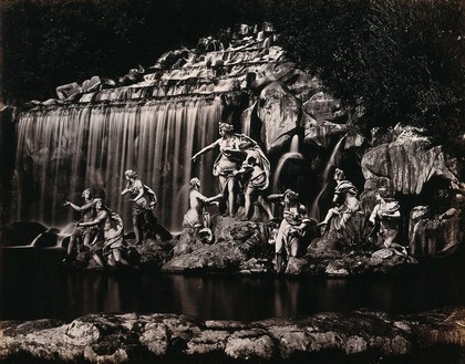 Caserta Royal Palace, Naples, Italy: Diana with her nymphs: sculptures in front of a waterfall in the palace gardens. Photograph, ca. 1870, of marble sculptures, ca. 1750.