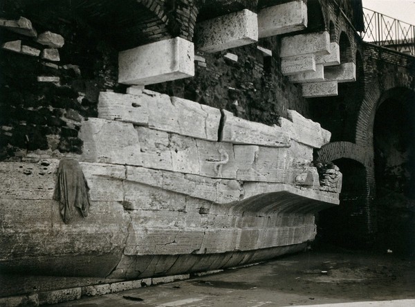 Temple of Aesculapius (in ruins), Isola Tiberina, Rome, Italy: the boat-shaped exterior with visible carved serpent and defaced head of Aesculapius. Photograph by Peter Johnston-Saint, 1929.