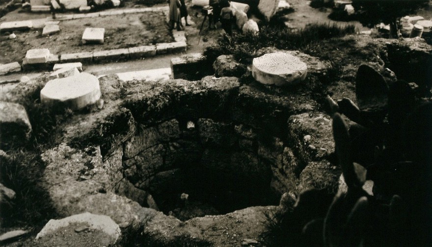 Remains of the temple of Aesculapius (Asklepieion), Athens: a round pit once used for holding sacred snakes. Photograph by Peter Johnston-Saint, 1930.