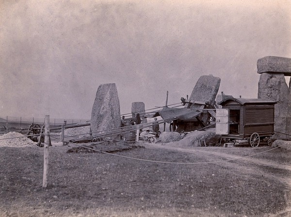 Stonehenge, England: straightening a leaning stone: pulleys, ropes and a wooden frame attached to the stone. Photograph, 1901.