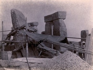 view Stonehenge, England: the straightening of a leaning stone which is attached to a wooden frame and pulleys: north west view. Photograph, 1901.