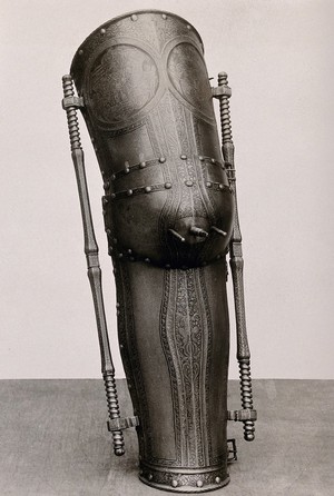 view A metal leg covering or prosthesis: decorative with spokes at the knee, housed at the German National Museum, Nürnberg. Photograph by Christof Müller, 1910/1930 (?).