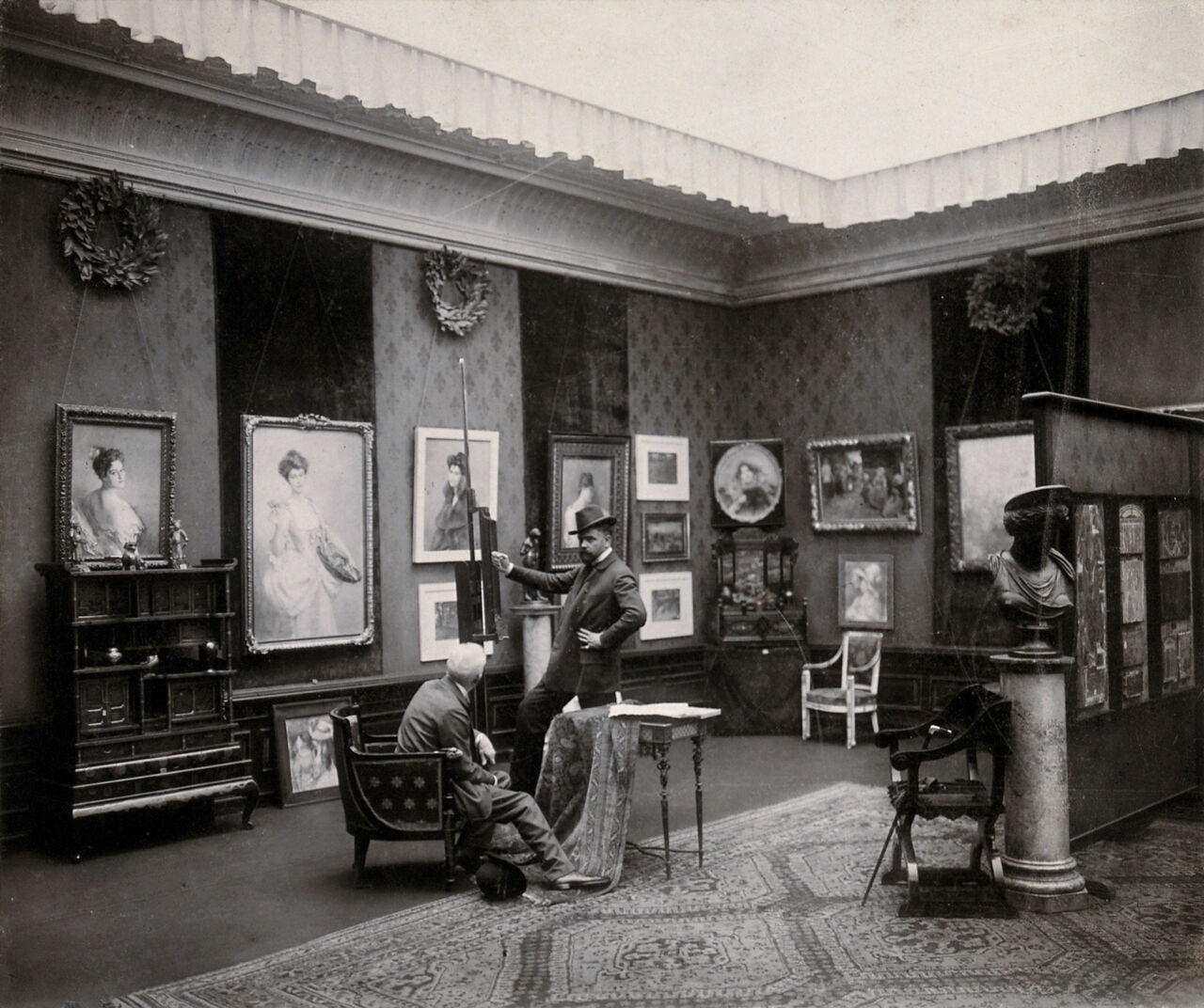Vienna, Austria: a showroom in which paintings and furniture are displayed, visited by two men. Photograph by J. Löwy., 1800-1899, by Josef Löwy
