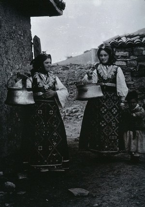 view Two Bulgarian women with a child wearing national dress.