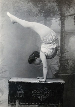 view A Bulgarian female acrobat standing on her hands.