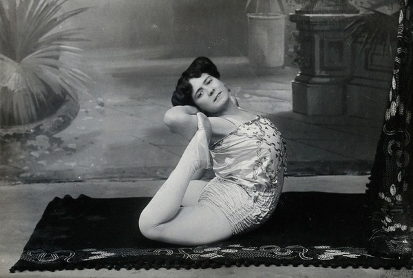 A Bulgarian female acrobat performing contortions in a photographic studio.