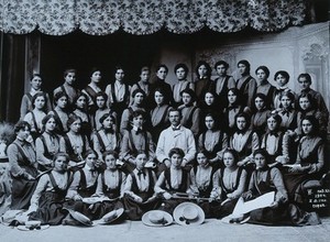 view A music teacher surrounded by his female pupils, in a studio setting in Sophia. Photograph, 1904.