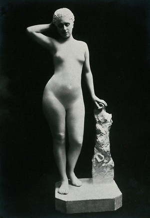 view A young woman, posing naked in a classical attitude, in a photographic studio. Photograph, ca.1900/1906.