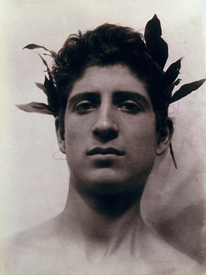 view Head of a Sicilian boy posing, crowned with laurel leaves. Photograph by W. von Gloeden, 1902.