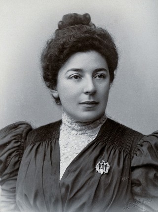 M. A. Slavina, in front of a plain, or airbrushed, background.
