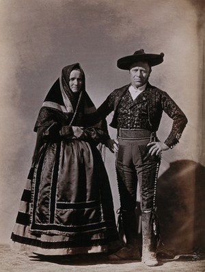 view People of Segovia, a man and woman wearing traditional dress.