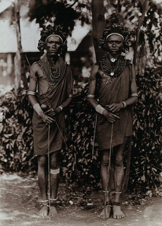 Two young Kikuyu men, carrying sticks. Photograph, ca.1900.